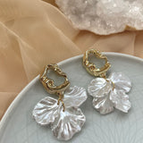 Abstract Gold earrings adorned with acrylic petals, designed for brides.