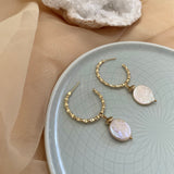 18k gold textured hoop earrings featuring a coin pearl