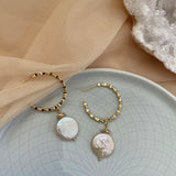 18k gold textured hoop earrings featuring a coin pearl