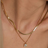 18k gold layered necklace featuring a diamond, designed to be waterproof and hypoallergenic for everyday wear.
