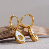 18k gold avocado earrings with a mother of pearl inner, designed to be hypoallergenic and tarnish-resistant for lasting wear