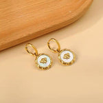 18k gold mother of pearl coin earrings featuring a bee motif and a removable pendant, allowing for two styling options. Waterproof, hypoallergenic, and tarnish-resistant