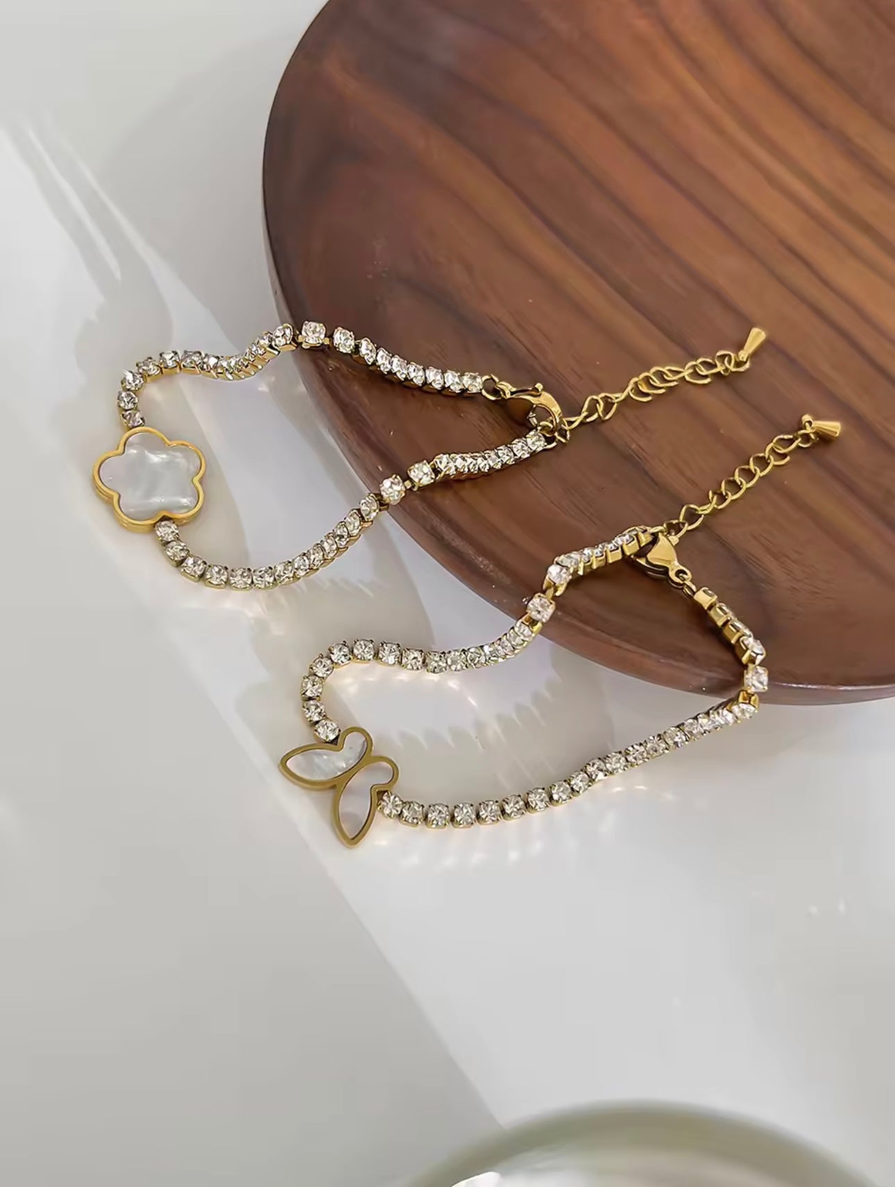 18k gold tennis bracelet featuring a butterfly and flower design with mother of pearl and high-quality cubic zirconia, crafted to be tarnish-resistant for enduring elegance