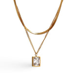 18k gold layered necklace featuring a diamond, designed to be waterproof and hypoallergenic for everyday wear.