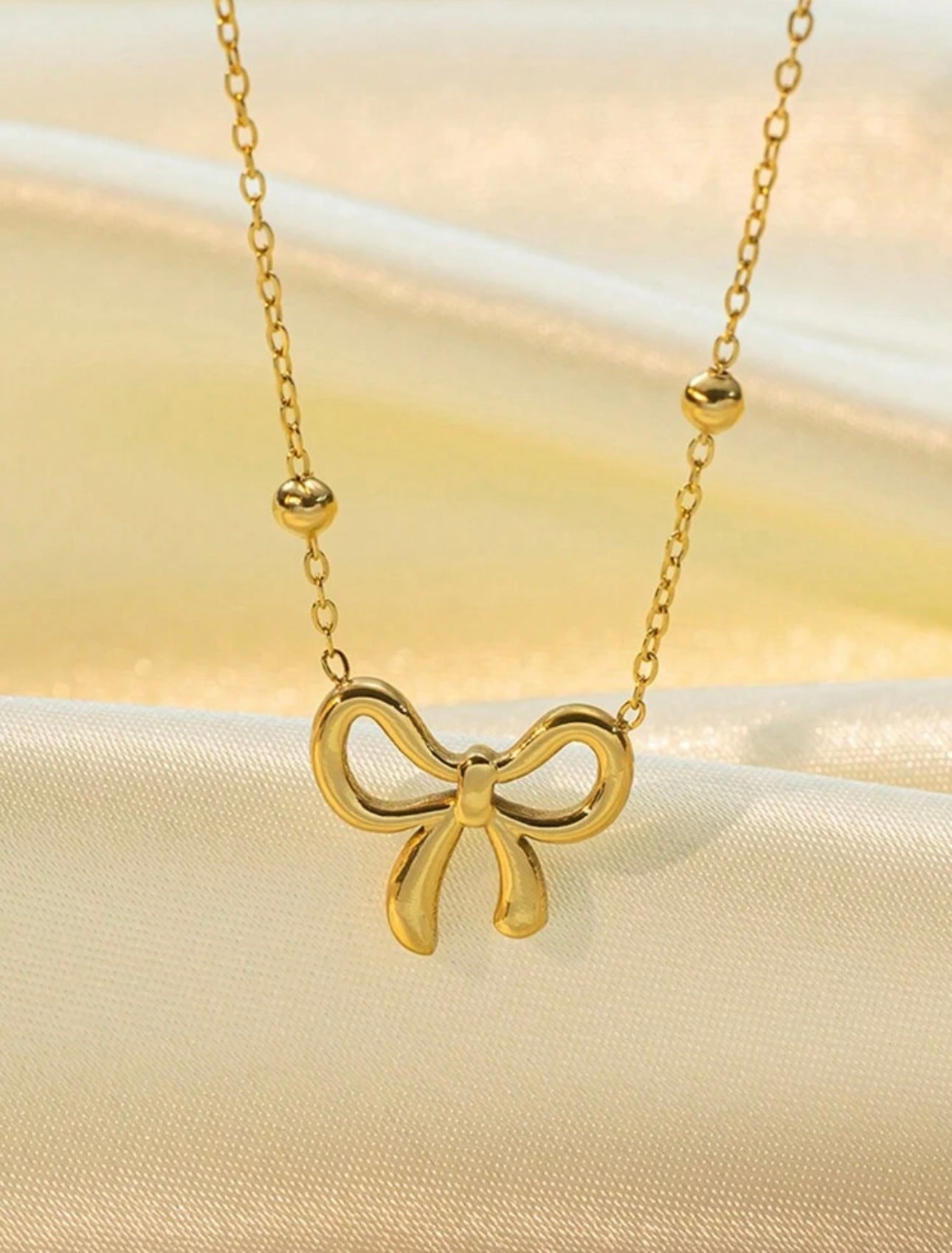 18k gold necklace satellite chain featuring a bow design, crafted to be waterproof and hypoallergenic for everyday wear