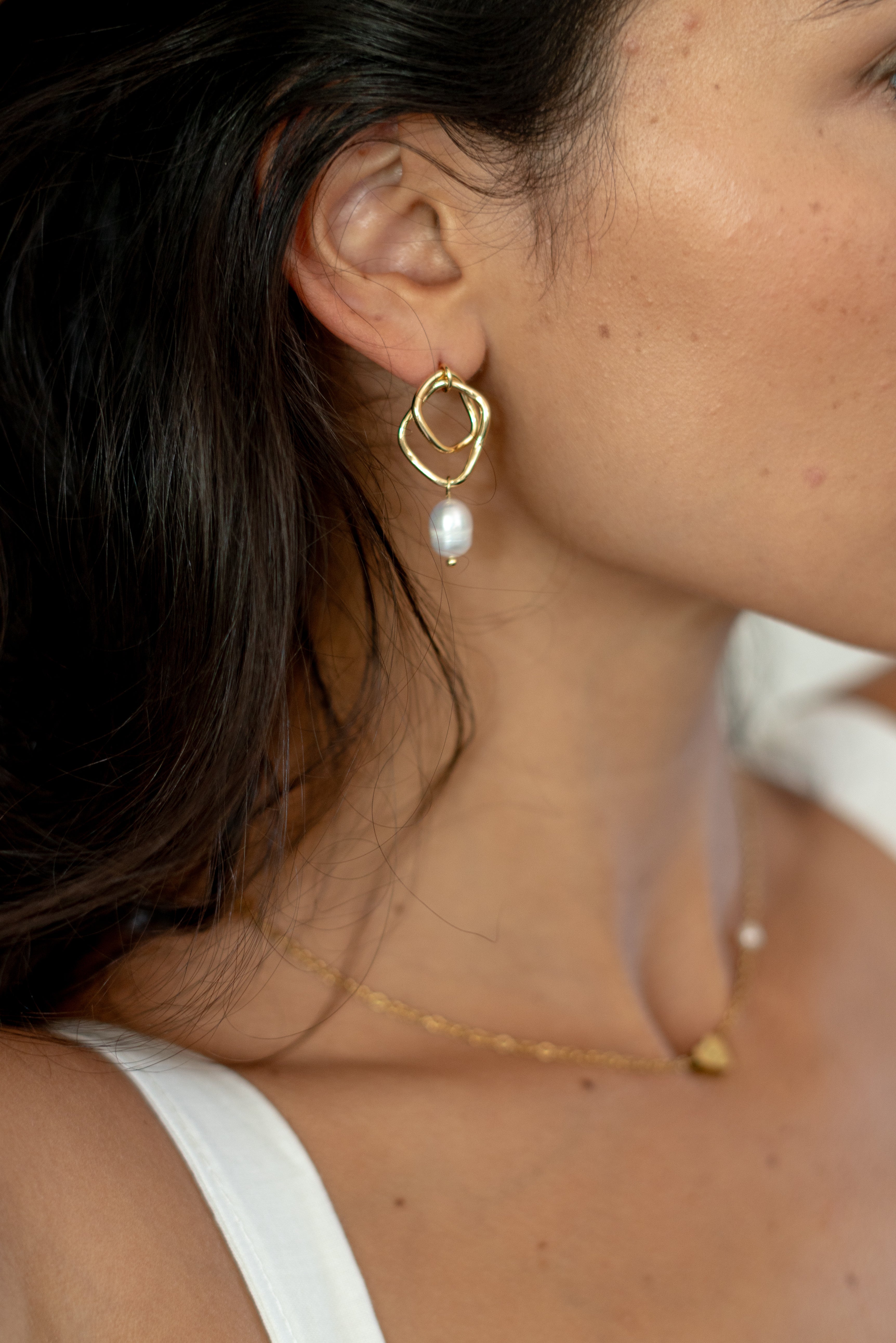 Abstract 18k gold earrings with a pearl drop, perfect for adding a unique and elegant touch to bridal attire