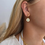 model wearing 18k gold mother of pearl coin earrings featuring a bee motif and a removable pendant, allowing for two styling options. Waterproof, hypoallergenic, and tarnish-resistant